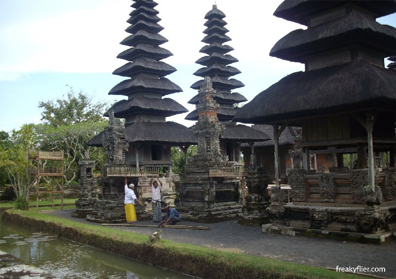 By the moat, men preparing for the ceremony