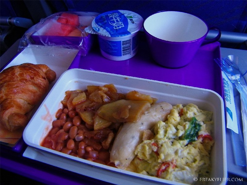 Western breakfast - Chicken sausage, scrambled eggs and baked beans with a croissant
