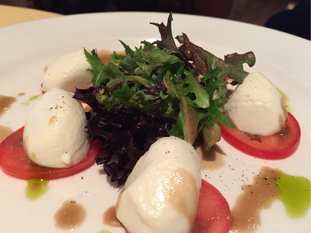 Mozarella and vine ripened tomatos with basil, anchovies and balsamic reduction